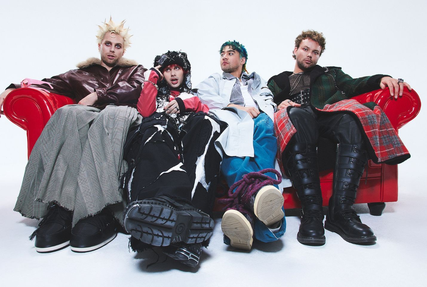 The band 5 seconds of summer sat on a red leather couch