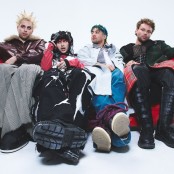 The band 5 seconds of summer sat on a red leather couch