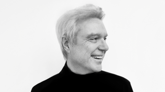 David Byrne smiling and looking into the distance