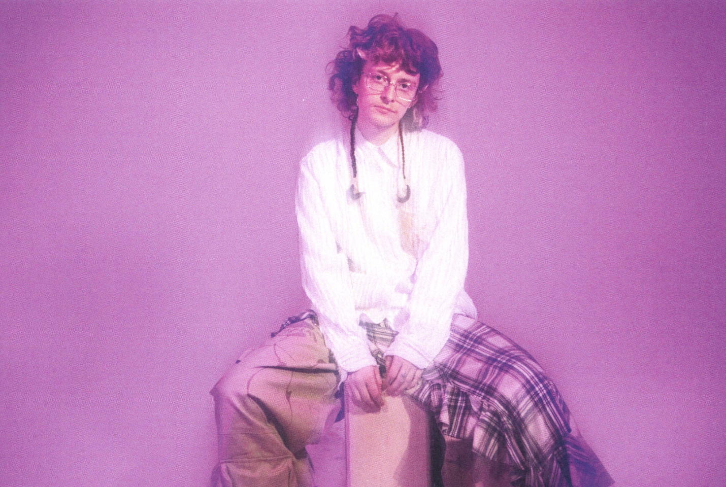 Artist Cavetown sitting against pink background