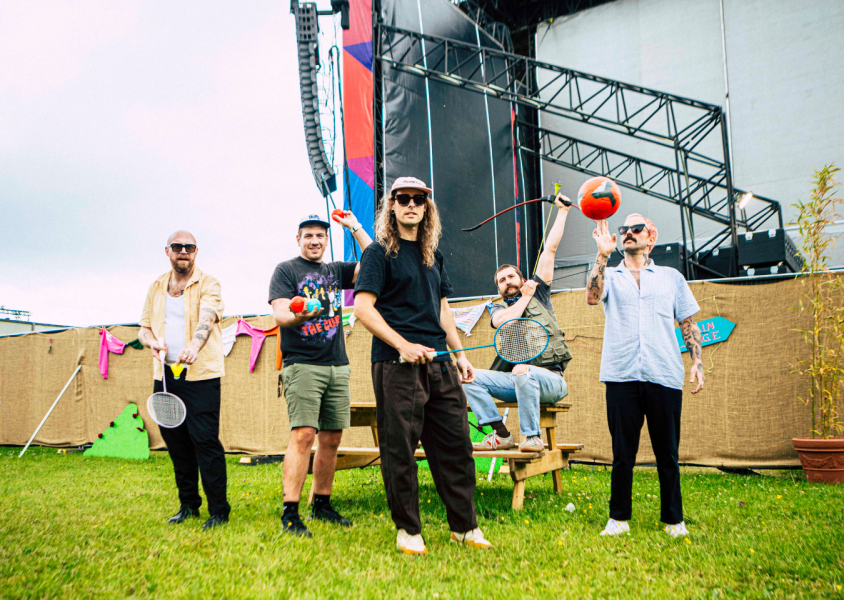 IDLES outside with badminton rackets and ballsx