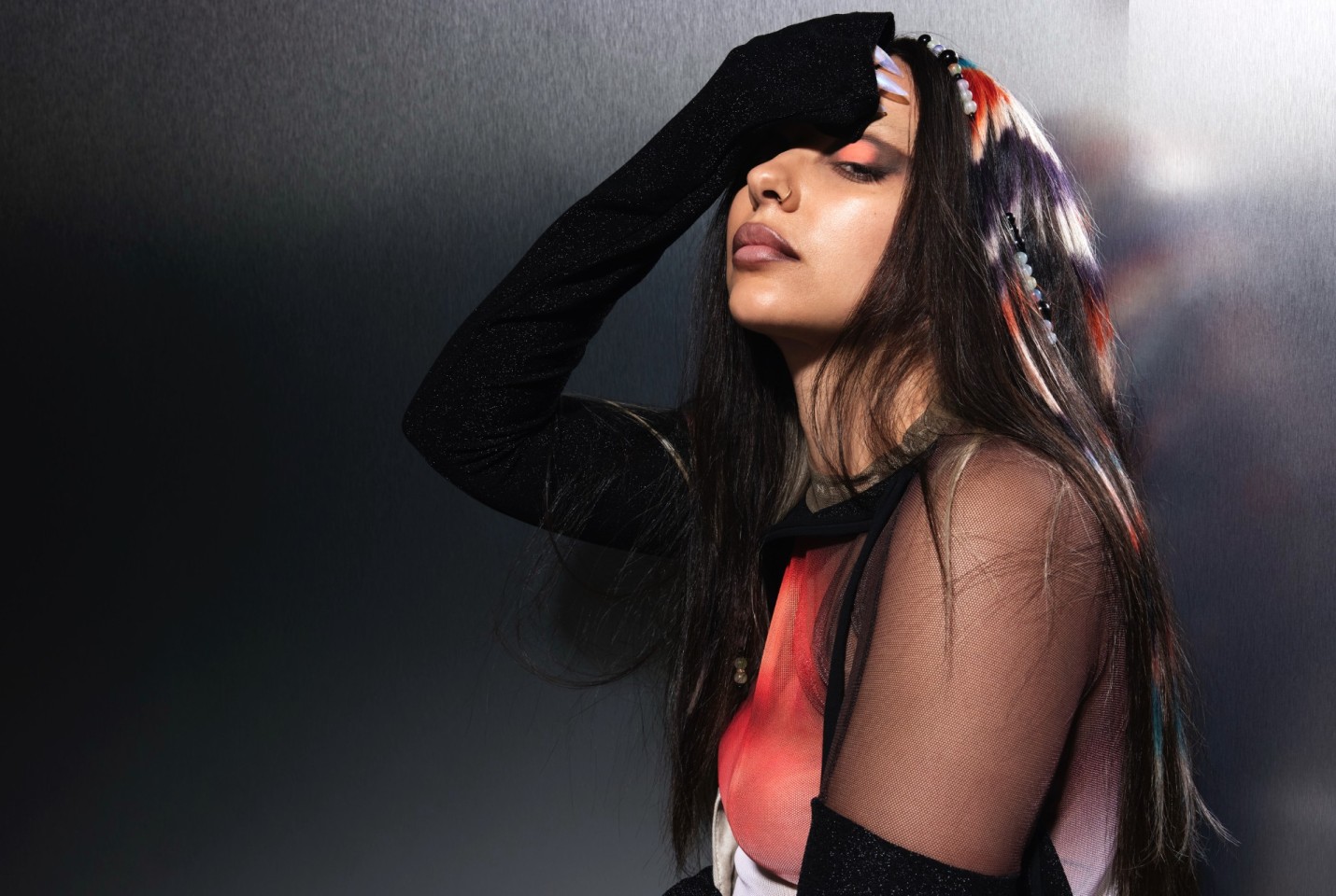 Jade looking into the camera with her hand on her forehead.