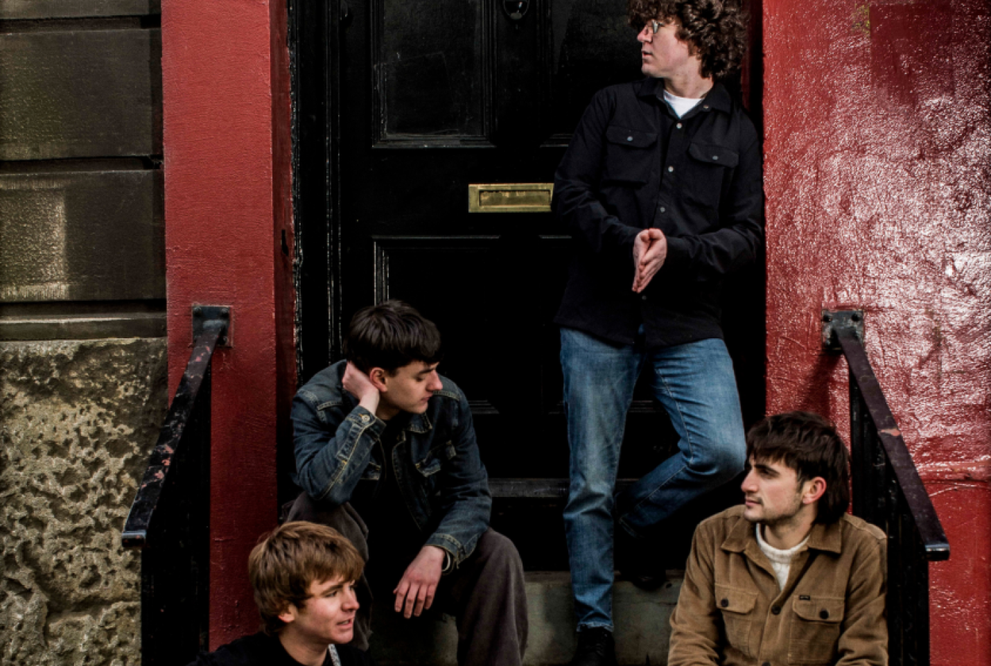 Keyside members, Dan Parker, Ben Cassidy,Oisin McAvoy and Max Gibson all posing in front of a black door
