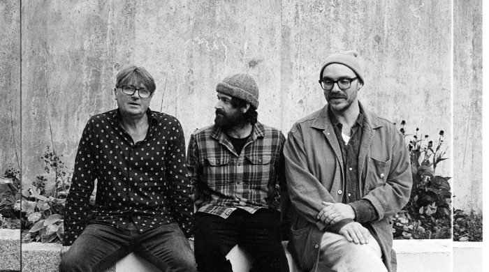 Members of the group LYR sat on a wall