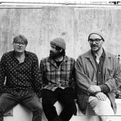 Members of the group LYR sat on a wall