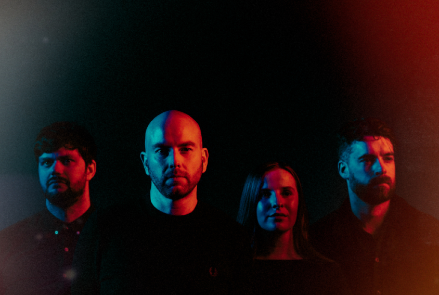 The band Lusa, with all the members looking into the distance.