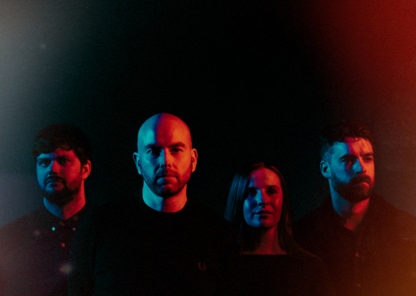 The band Lusa, with all the members looking into the distance.x