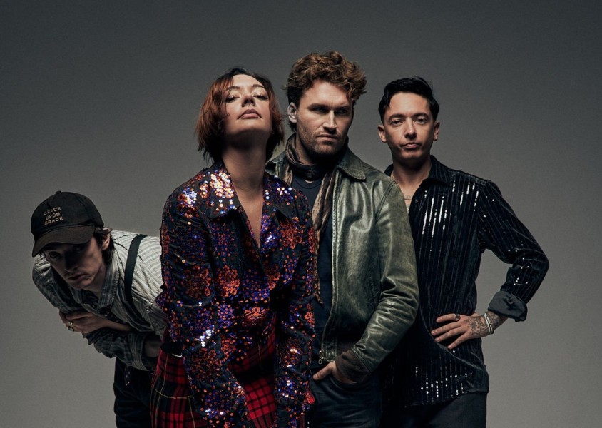 band posing against grey backgroundx