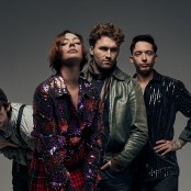 band posing against grey background