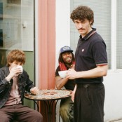 three men outside a coffee shop