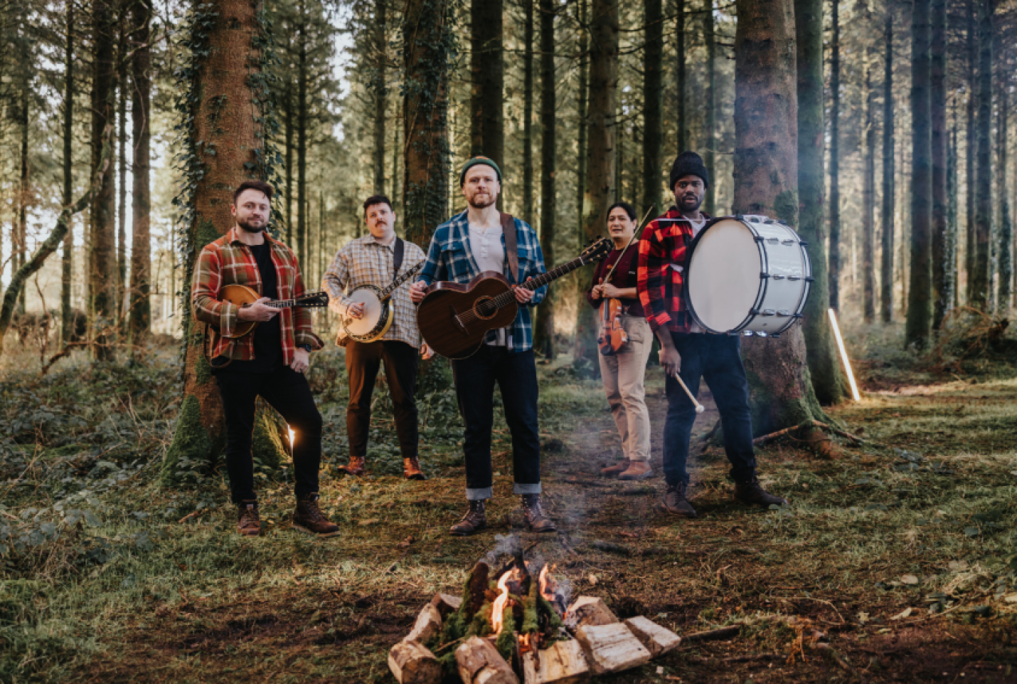 The Rend Collective members, Chris Llewelly, Stephen Mitchell, Will Pearce, Jonathan Chu and Daniel Jones standing in the woods and looking into the camera.