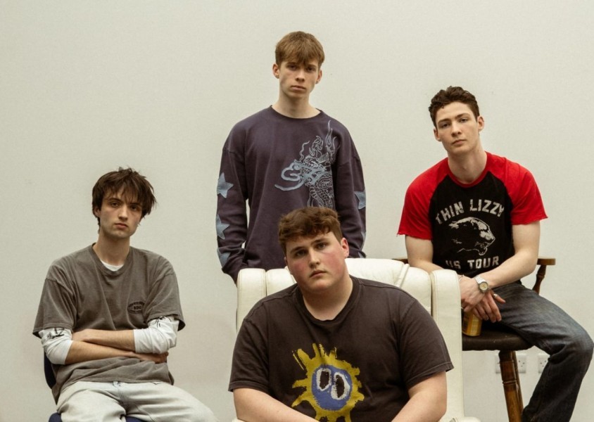 The band Spectral View, with the members sitting down looking at the camera.x