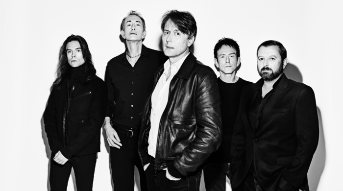 black and white picture of 5 men standing against white background