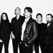 black and white picture of 5 men standing against white background