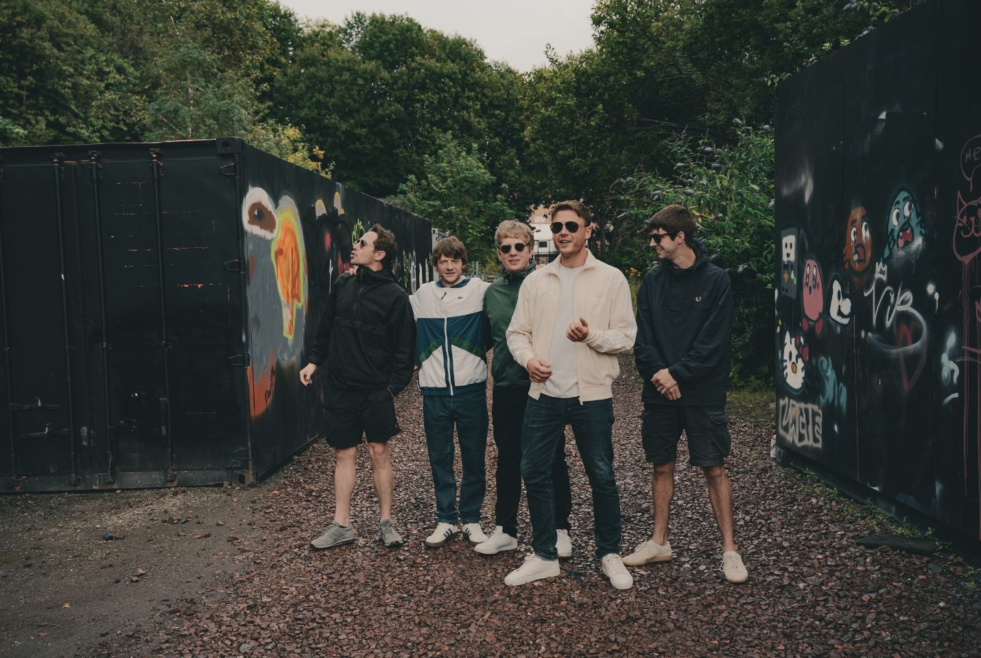 5 men posing outdoors 