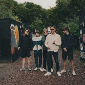 5 men posing outdoors