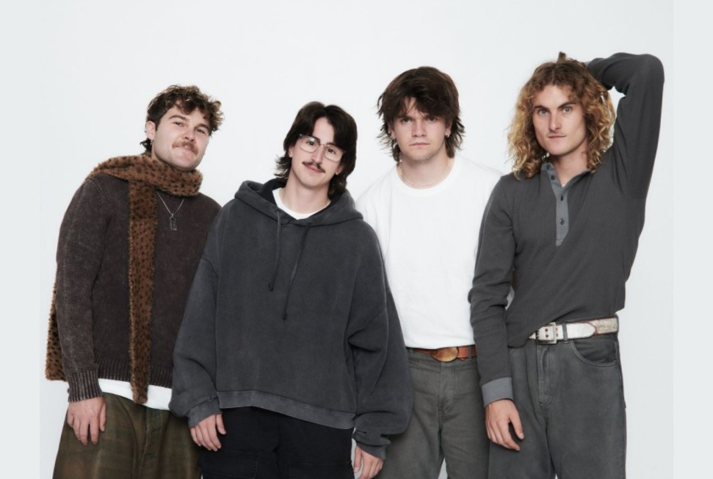 The Teenage Dads members, Joran Finlay, Connor McLaughlin, Vincent Kinna and Angus Christie looking into the camera smiling.