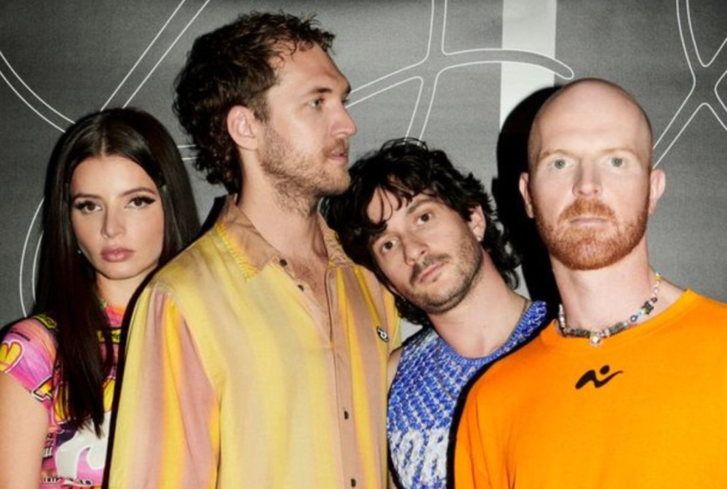 The band The Jungle Giants with members Sam Hales, Cesira Aitken, and Andrew Dooris looking at the camera, with Keelan Bijker looking into the distance.