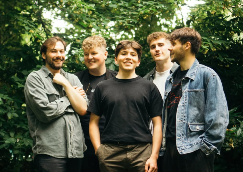Members of the band 'Waverly' standing outside in a forestx
