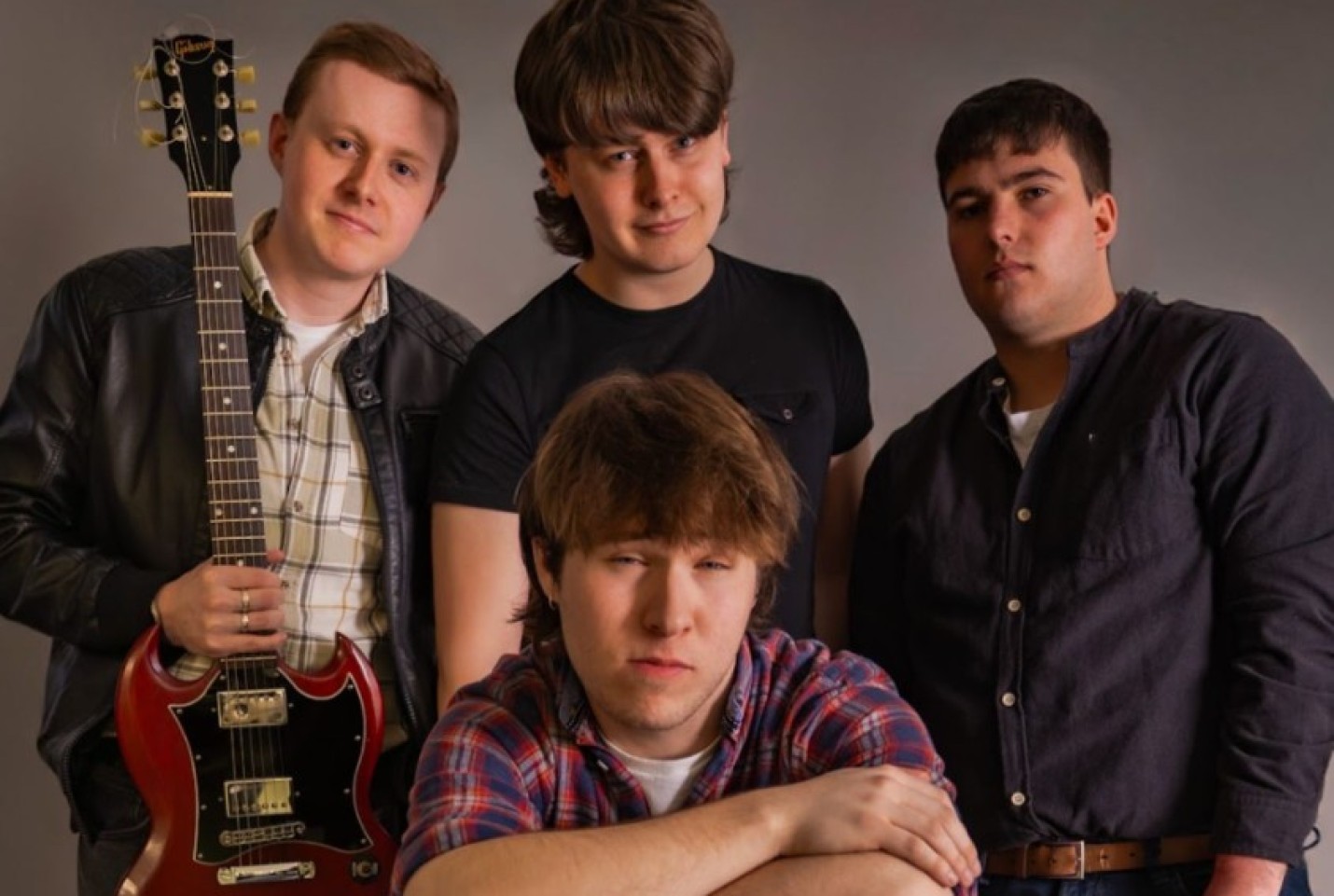 The band Warm Reekin Rich, the members smiling into the camera