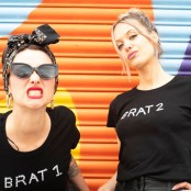 two woman stood in front of a colourful door